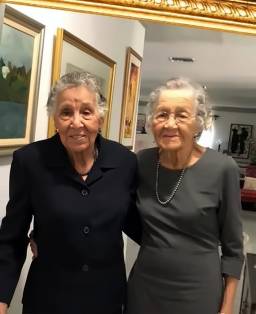 Olga and Aileen standing together at home