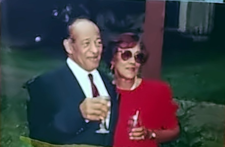 Sybil and Bob Black raising glasses together outdoors