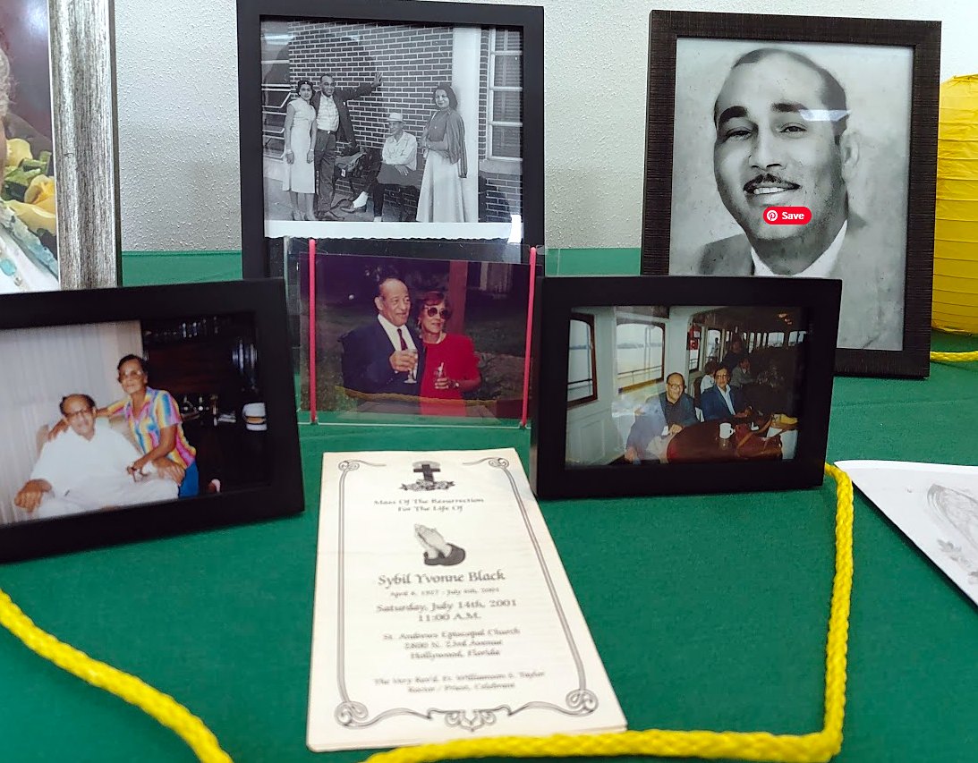 Framed family photos of Sybil and Bob displayed beside her memorial program at a family reunion